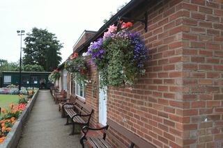 A brick bowls club pavilion beside the green